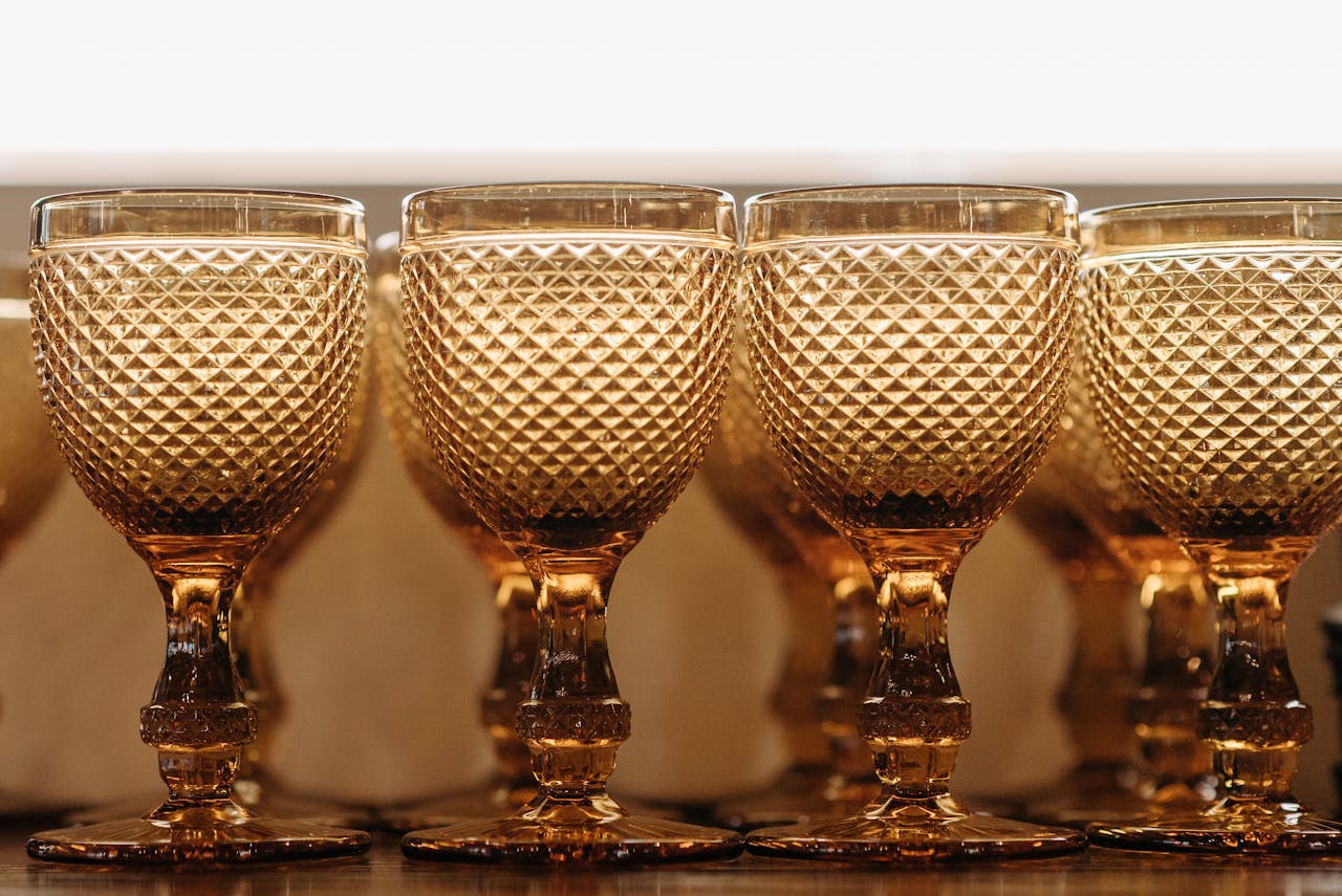 Close-up of elegant amber goblets with a textured diamond pattern, perfect for upscale dining.
